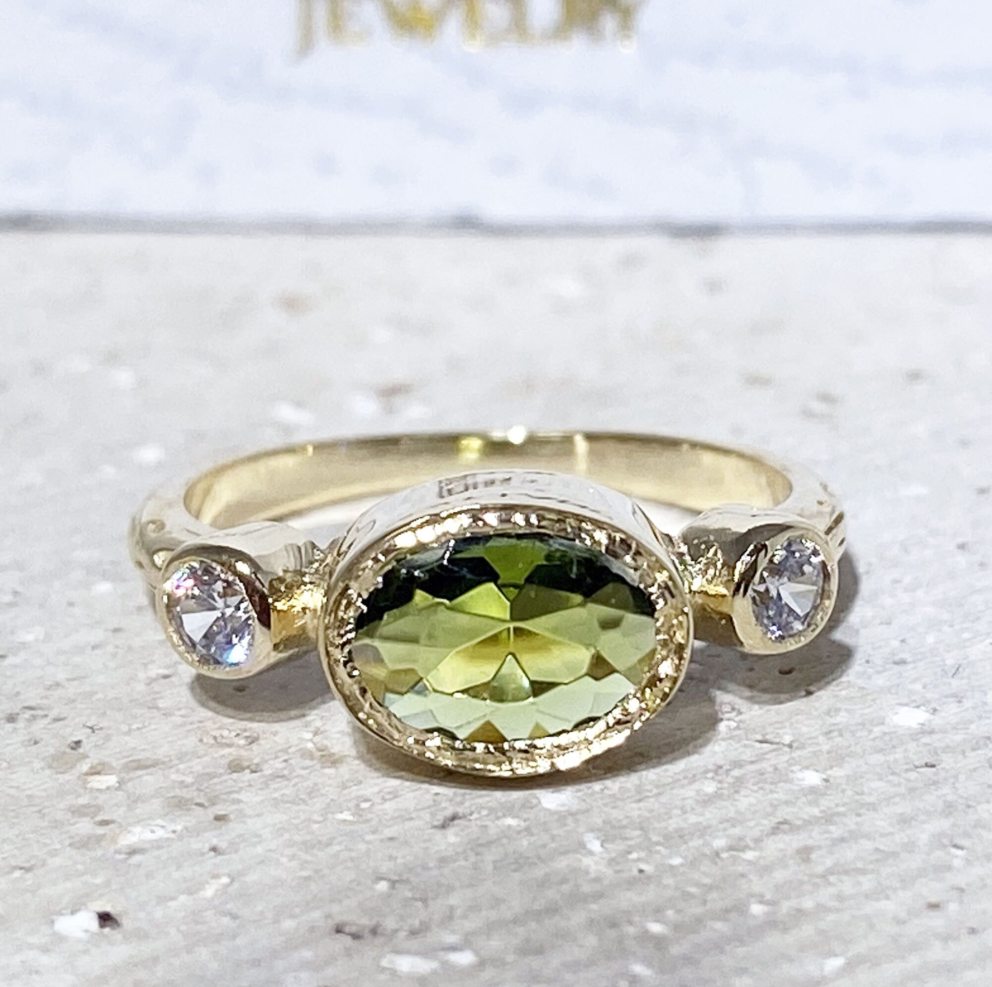 Oval Peridot Three Stone Bezel Ring with Clear Quartz Accents - H.L.Jewelry