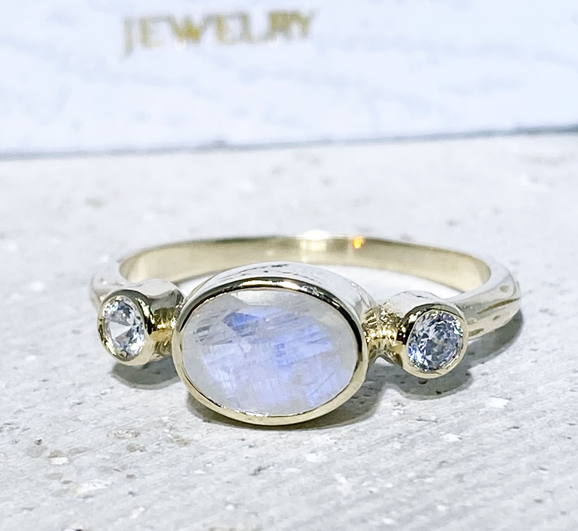 Oval Rainbow Moonstone Three Stone Bezel Ring with Clear Quartz Accents - H.L.Jewelry