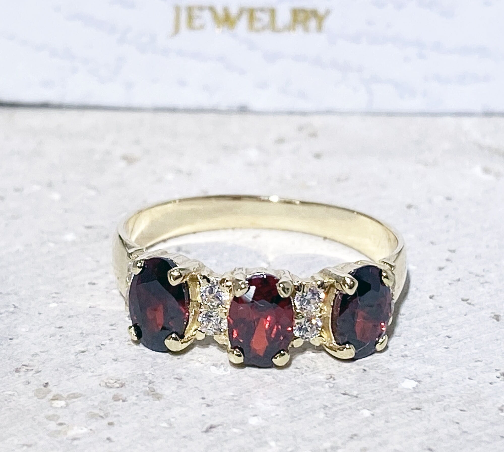 Oval Red Garnet Three-Stone Ring with Clear Quartz Accents - H.L.Jewelry