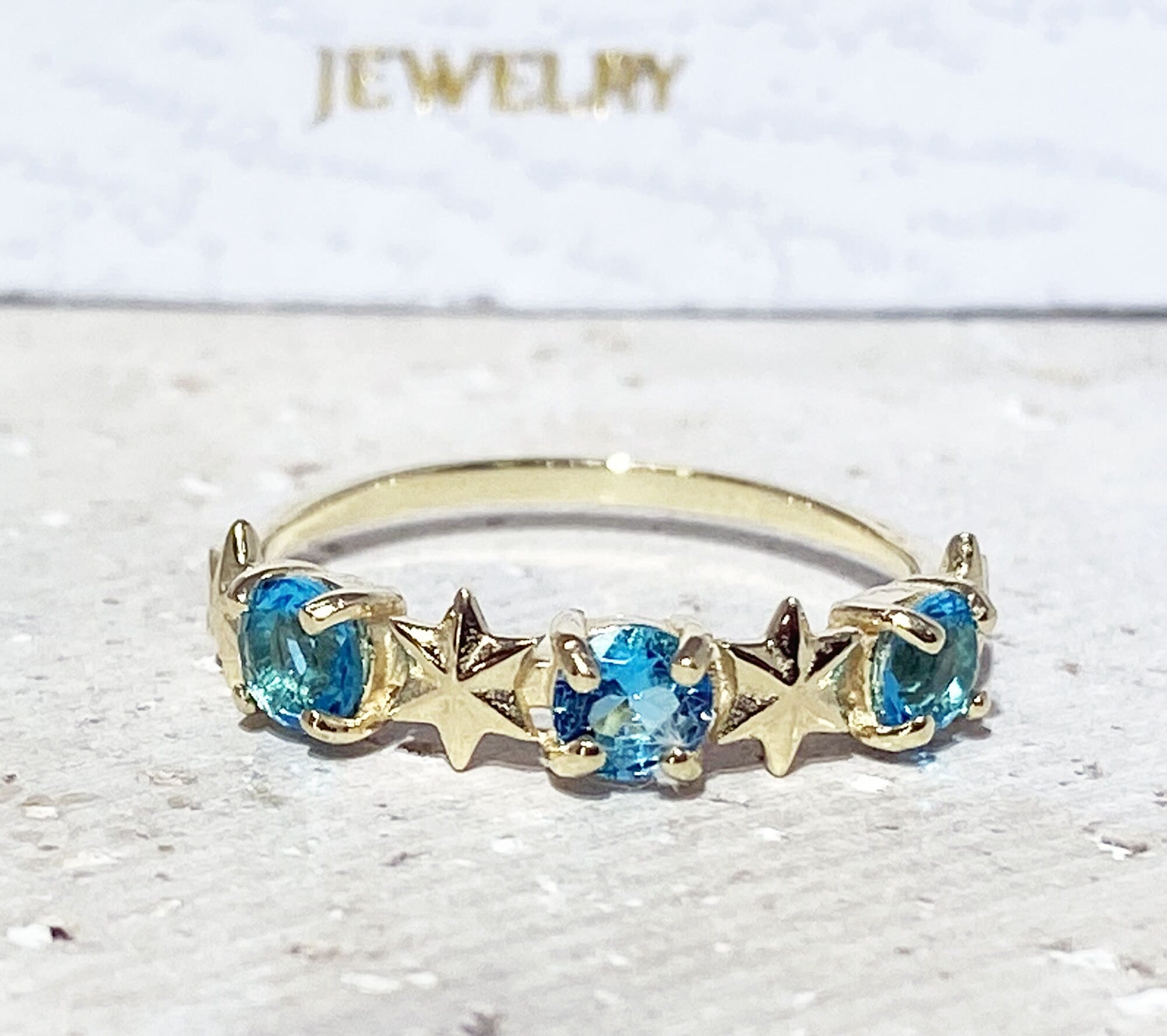 Round Blue Topaz Three Stone Ring with Star Accents - H.L.Jewelry