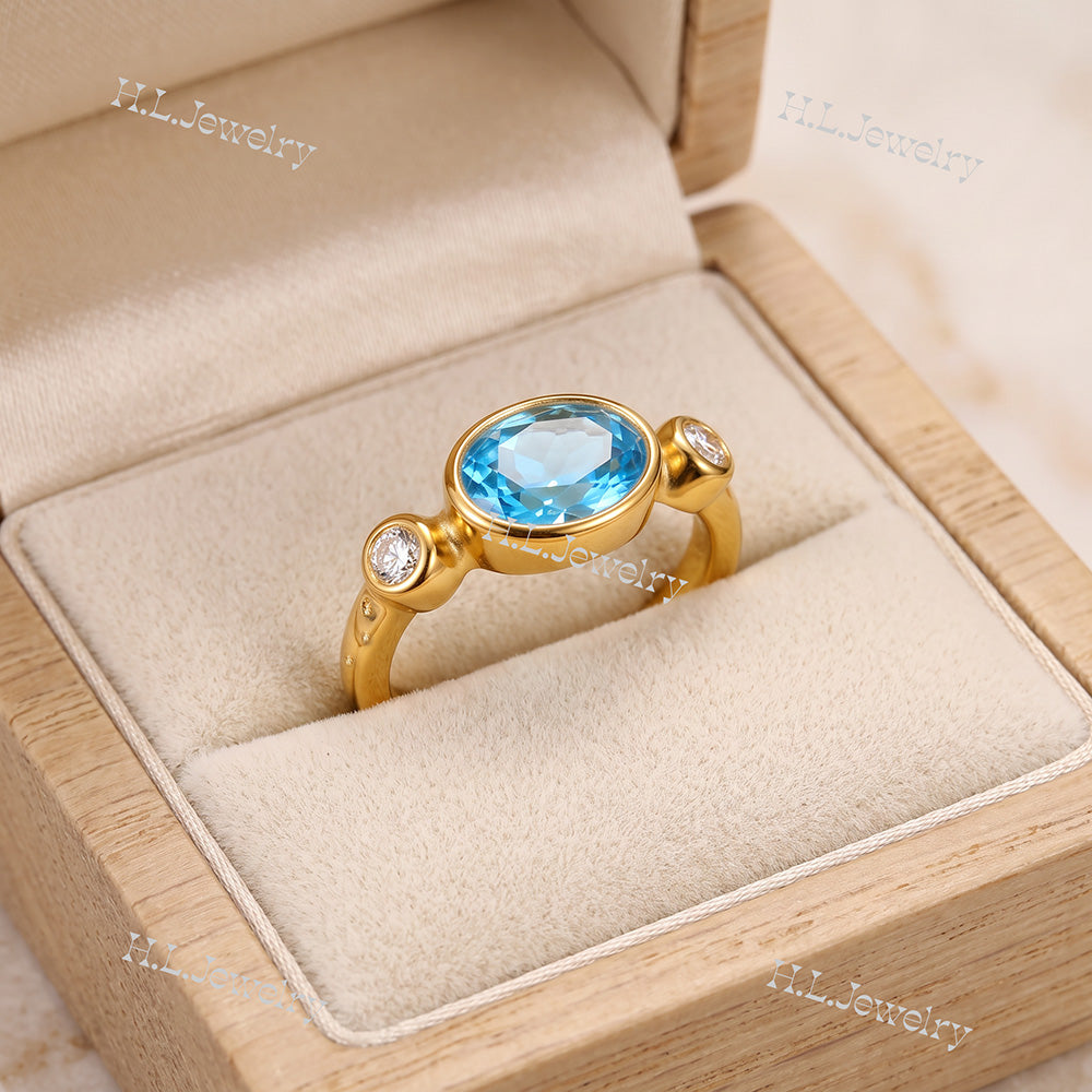 Oval Blue Topaz Bezel-Set Ring with Clear Quartz Accents - H.L.Jewelry