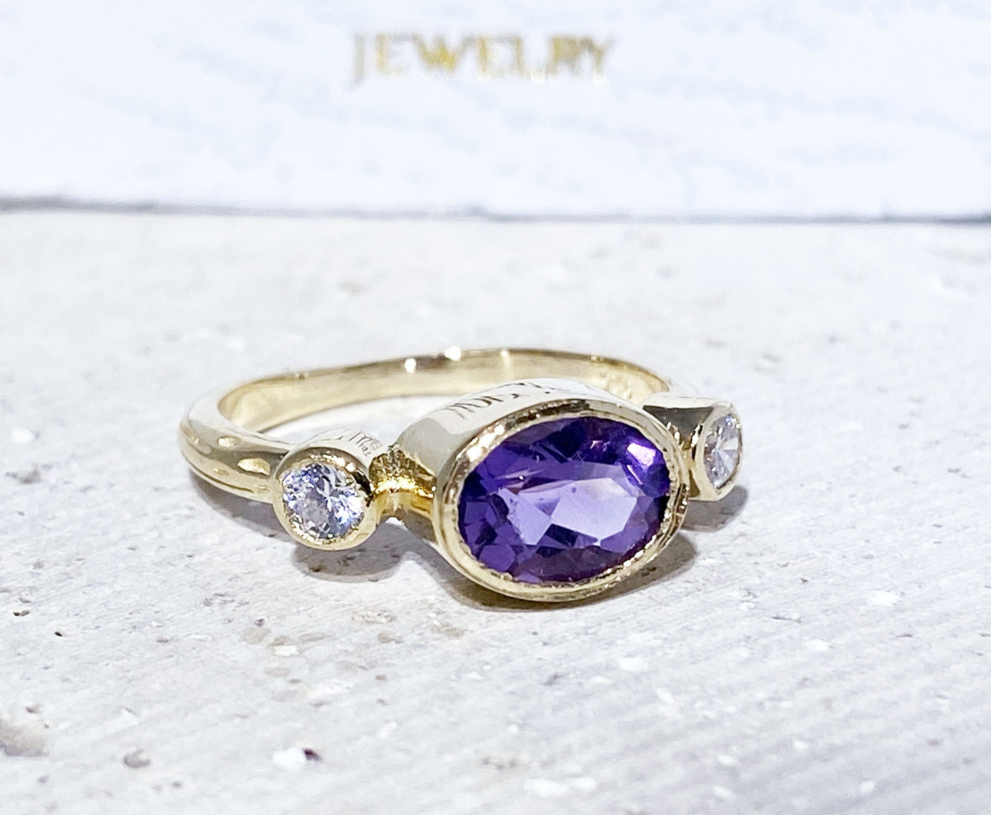Oval Amethyst Three Stone Bezel Ring with Clear Quartz Accents - H.L.Jewelry