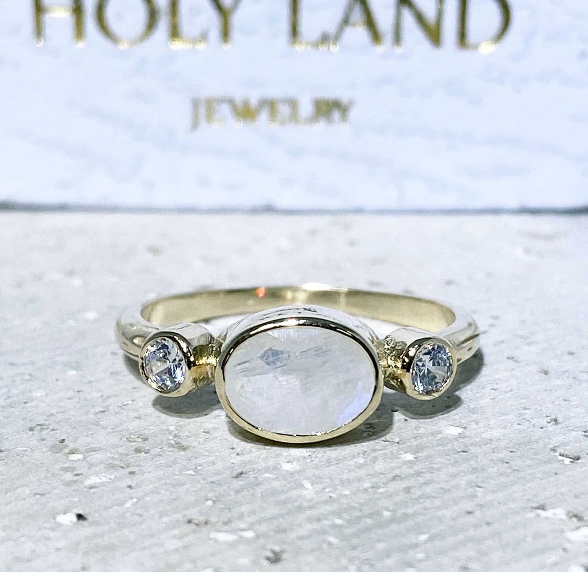 Oval Rainbow Moonstone Three Stone Bezel Ring with Clear Quartz Accents - H.L.Jewelry