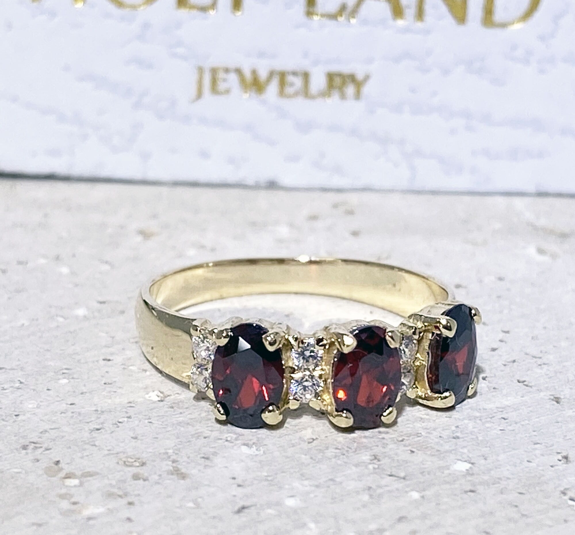 Oval Red Garnet Three-Stone Ring with Clear Quartz Accents - H.L.Jewelry