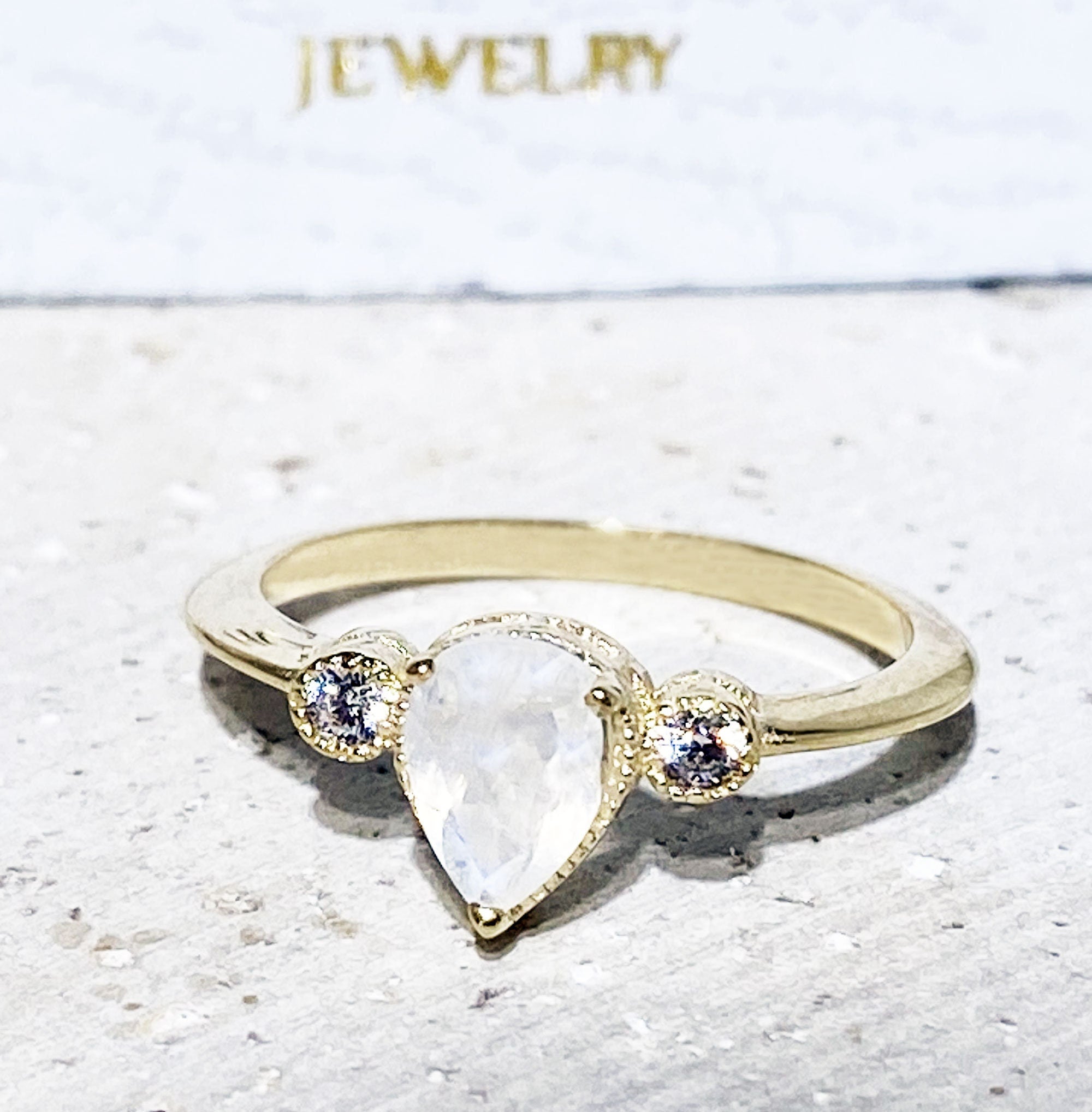 Pear-Shaped Rainbow Moonstone Bezel Ring with Clear Quartz Accents - H.L.Jewelry