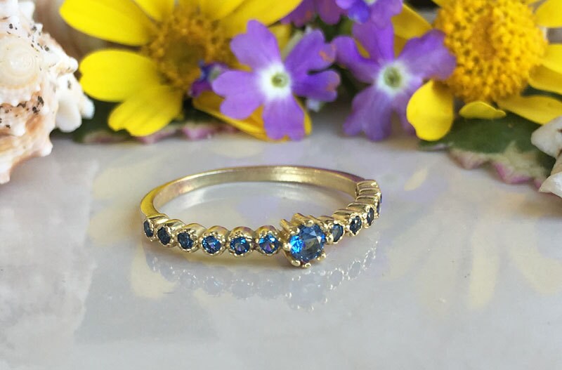 Blue Topaz Ring - December Birthstone  - Delicate Stacking Half Eternity Ring with Thirteen Round Blue Topaz Gemstones - H.L.Jewelry