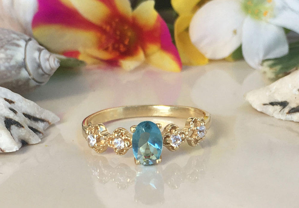 Blue Topaz Ring - December Birthstone - Delicate Ring with Oval Blue Topaz Gemstone and Flower Setting with Clear Quartz Accents - H.L.Jewelry