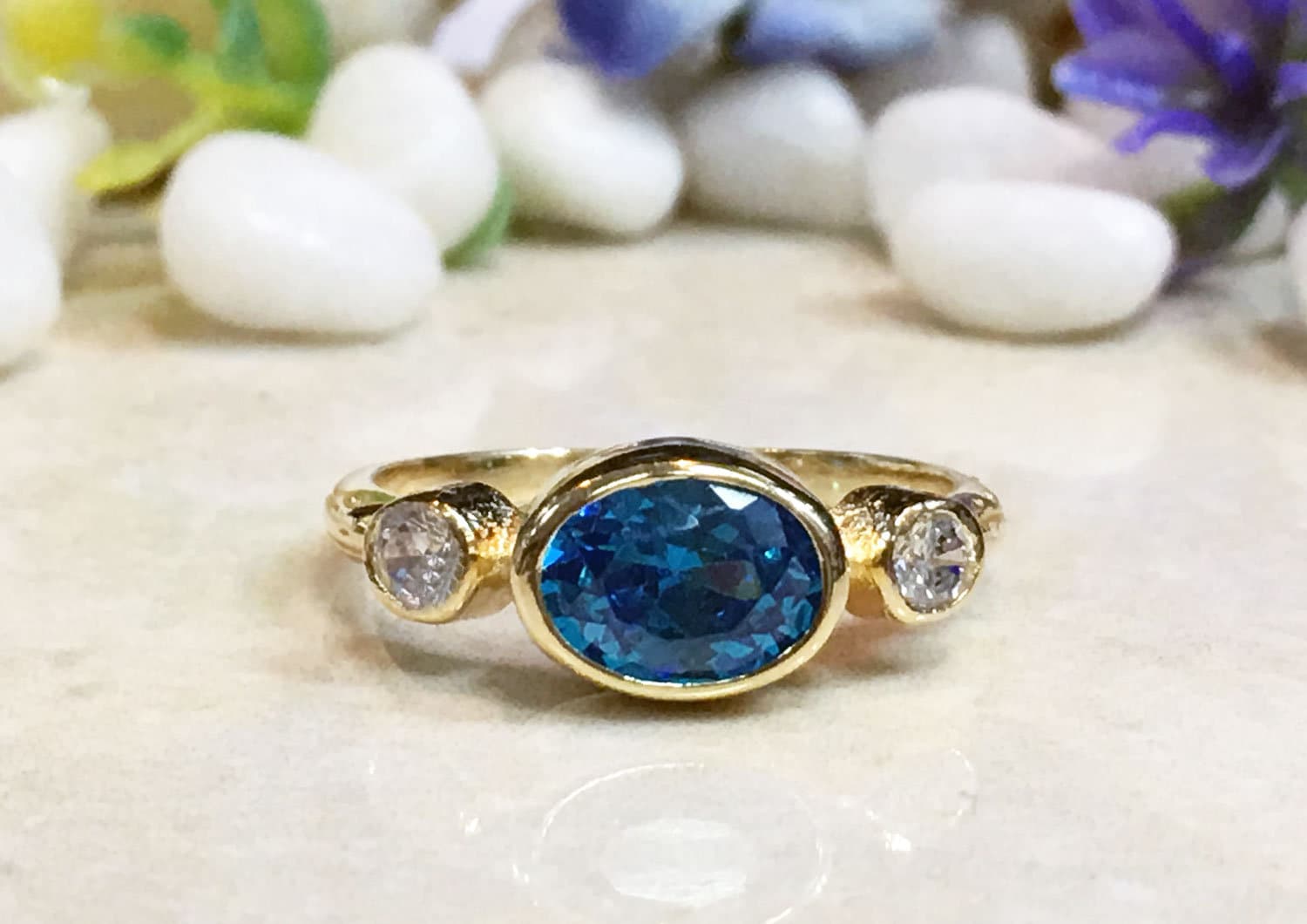 Blue Topaz Ring - December Birthstone - Bezel Set Ring with Oval Blue Topaz Gemstone and Clear Quartz Accents - H.L.Jewelry