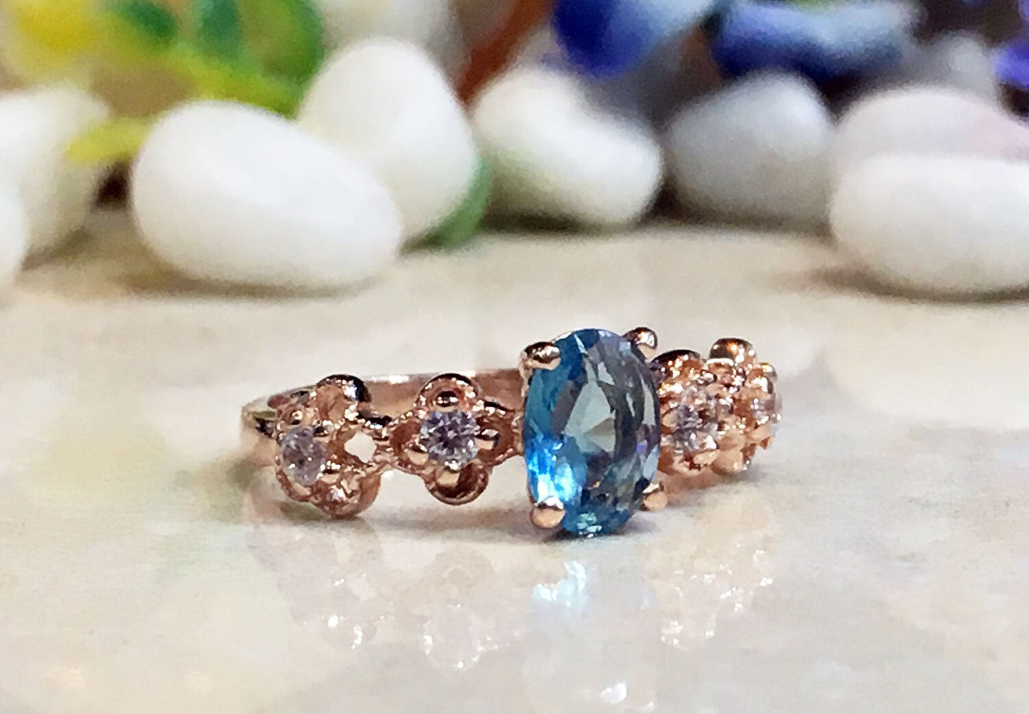 Blue Topaz Ring - December Birthstone - Delicate Ring with Oval Blue Topaz Gemstone and Flower Setting with Clear Quartz Accents - H.L.Jewelry