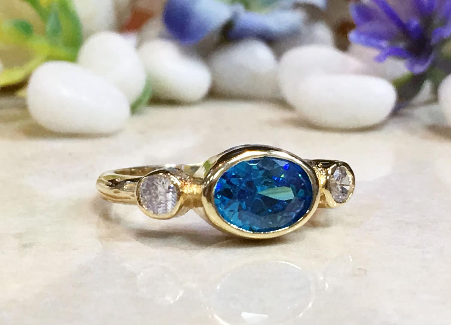 Blue Topaz Ring - December Birthstone - Bezel Set Ring with Oval Blue Topaz Gemstone and Clear Quartz Accents - H.L.Jewelry