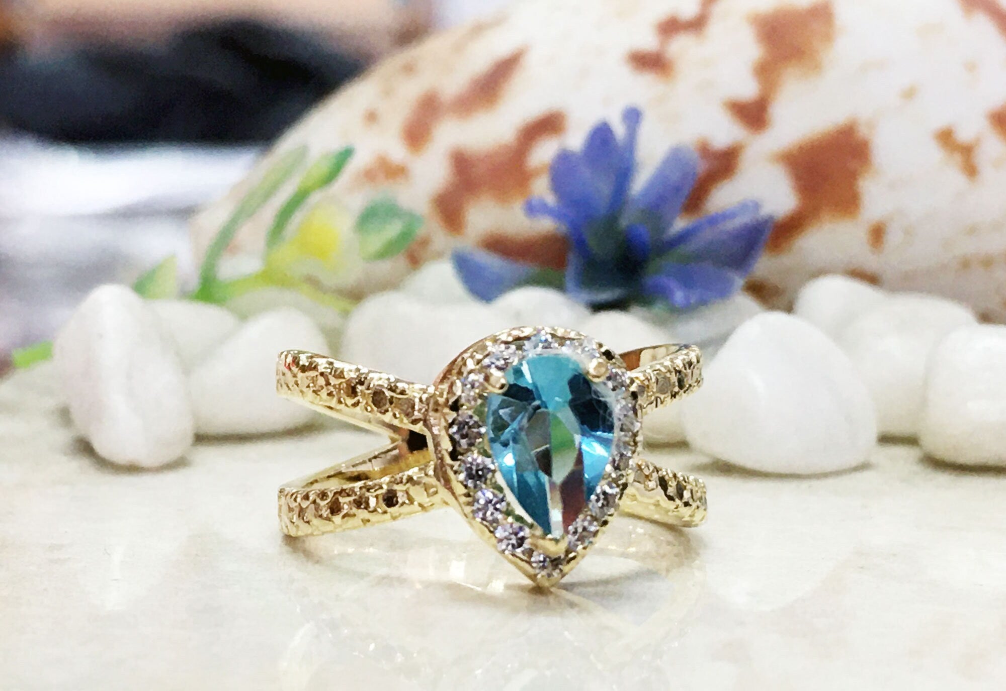 Blue Topaz Ring - December Birthstone - Statement Engagement Ring with Pear-Shaped Blue Topaz Gemstone and Clear Quartz Halo - H.L.Jewelry