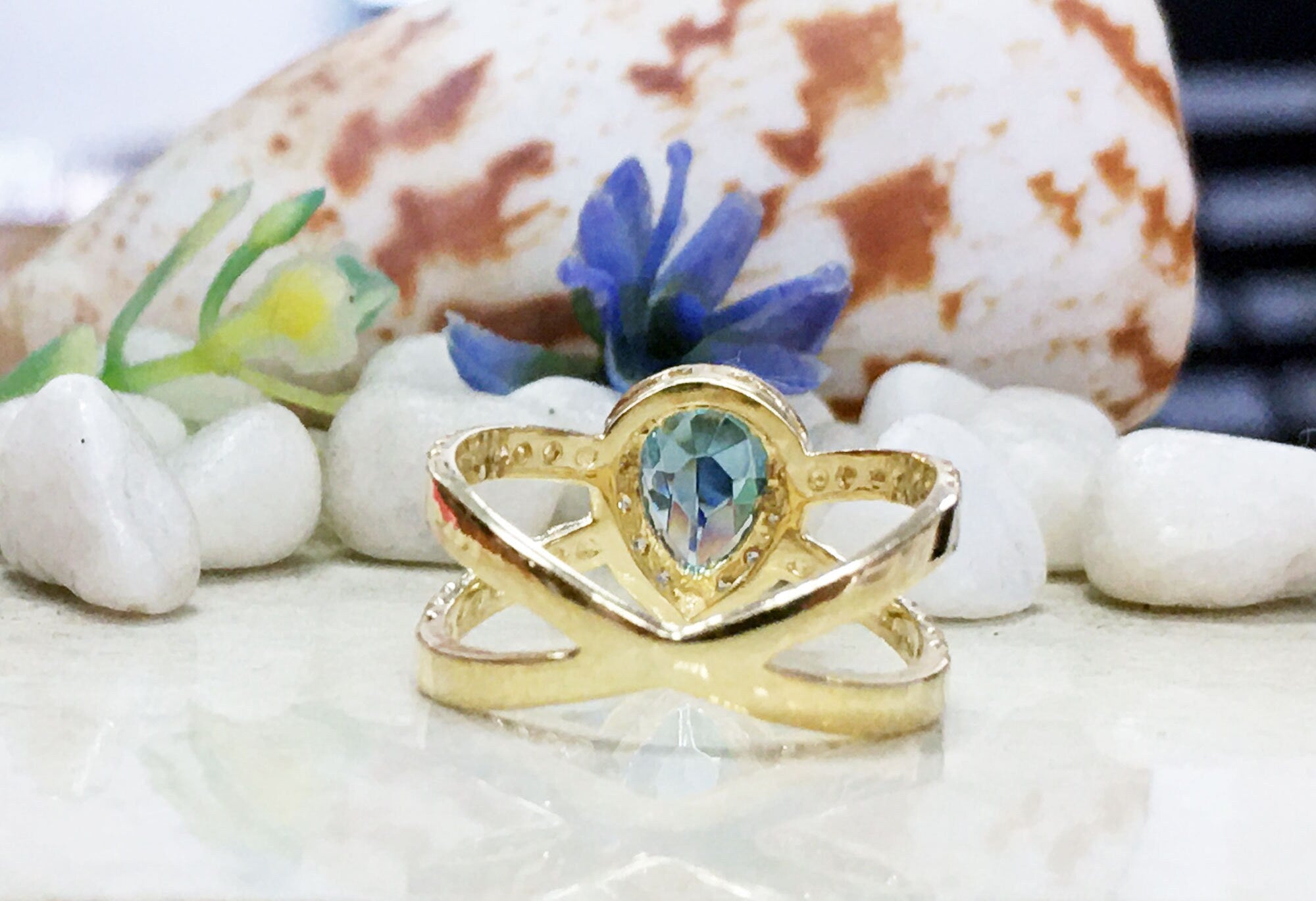 Blue Topaz Ring - December Birthstone - Statement Engagement Ring with Pear-Shaped Blue Topaz Gemstone and Clear Quartz Halo - H.L.Jewelry