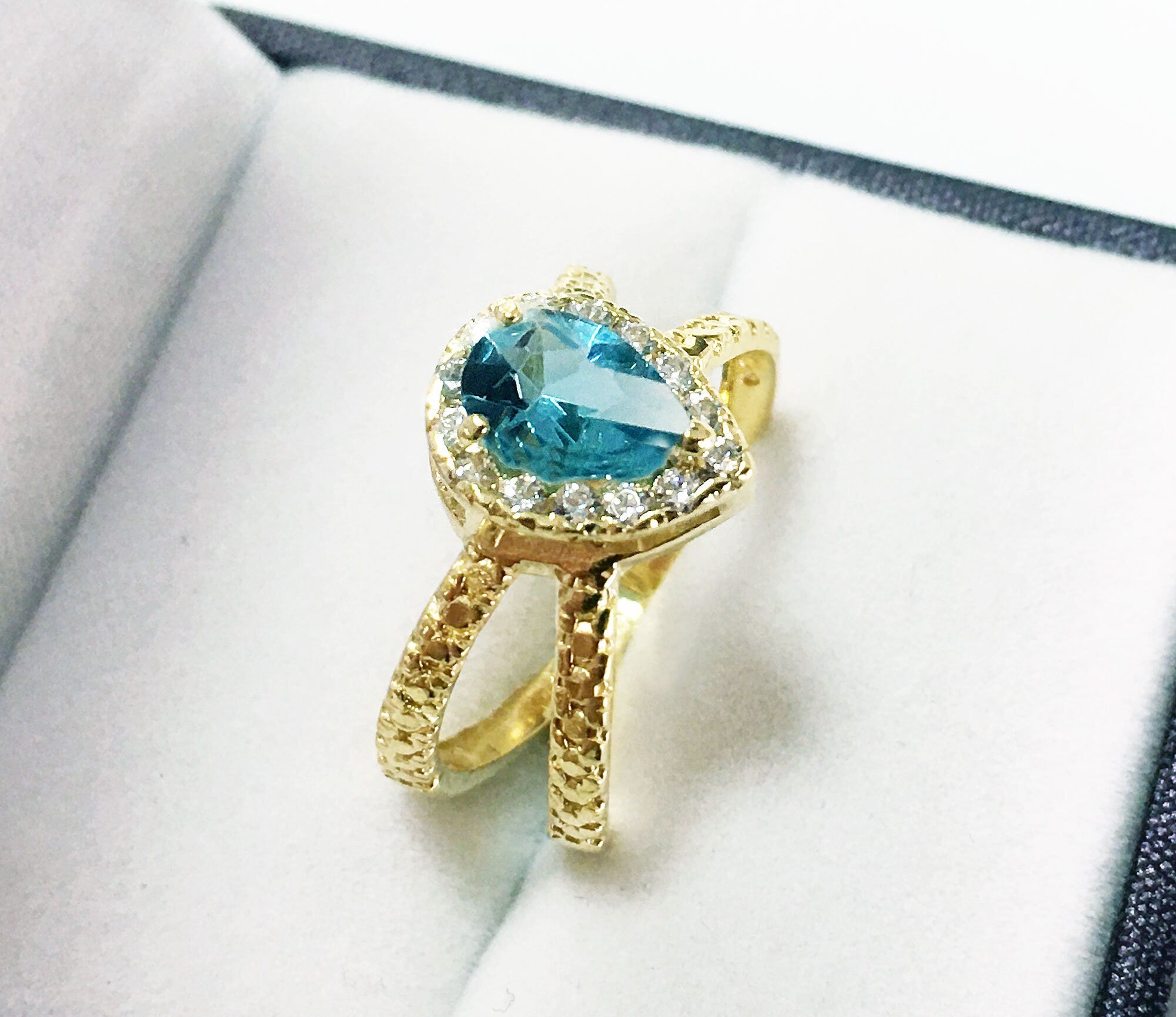 Blue Topaz Ring - December Birthstone - Statement Engagement Ring with Pear-Shaped Blue Topaz Gemstone and Clear Quartz Halo - H.L.Jewelry