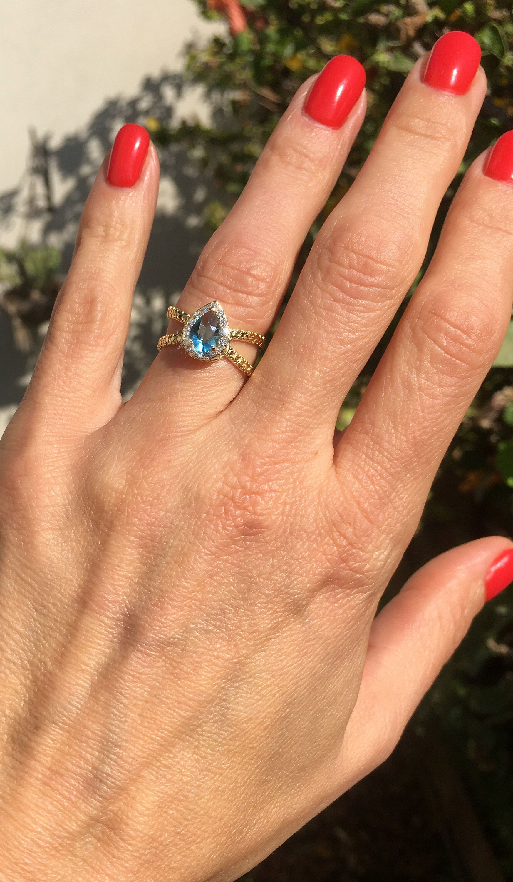 Blue Topaz Ring - December Birthstone - Statement Engagement Ring with Pear-Shaped Blue Topaz Gemstone and Clear Quartz Halo - H.L.Jewelry