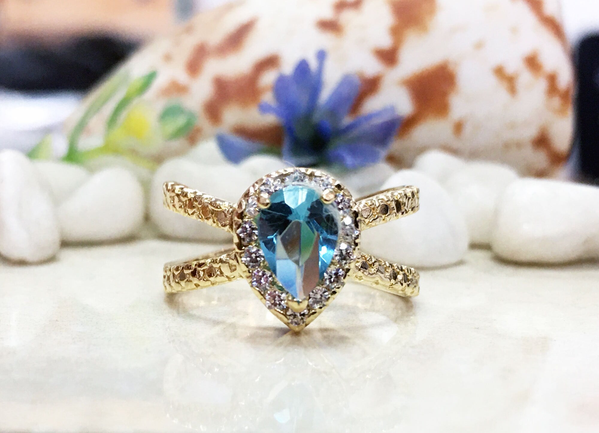 Blue Topaz Ring - December Birthstone - Statement Engagement Ring with Pear-Shaped Blue Topaz Gemstone and Clear Quartz Halo - H.L.Jewelry