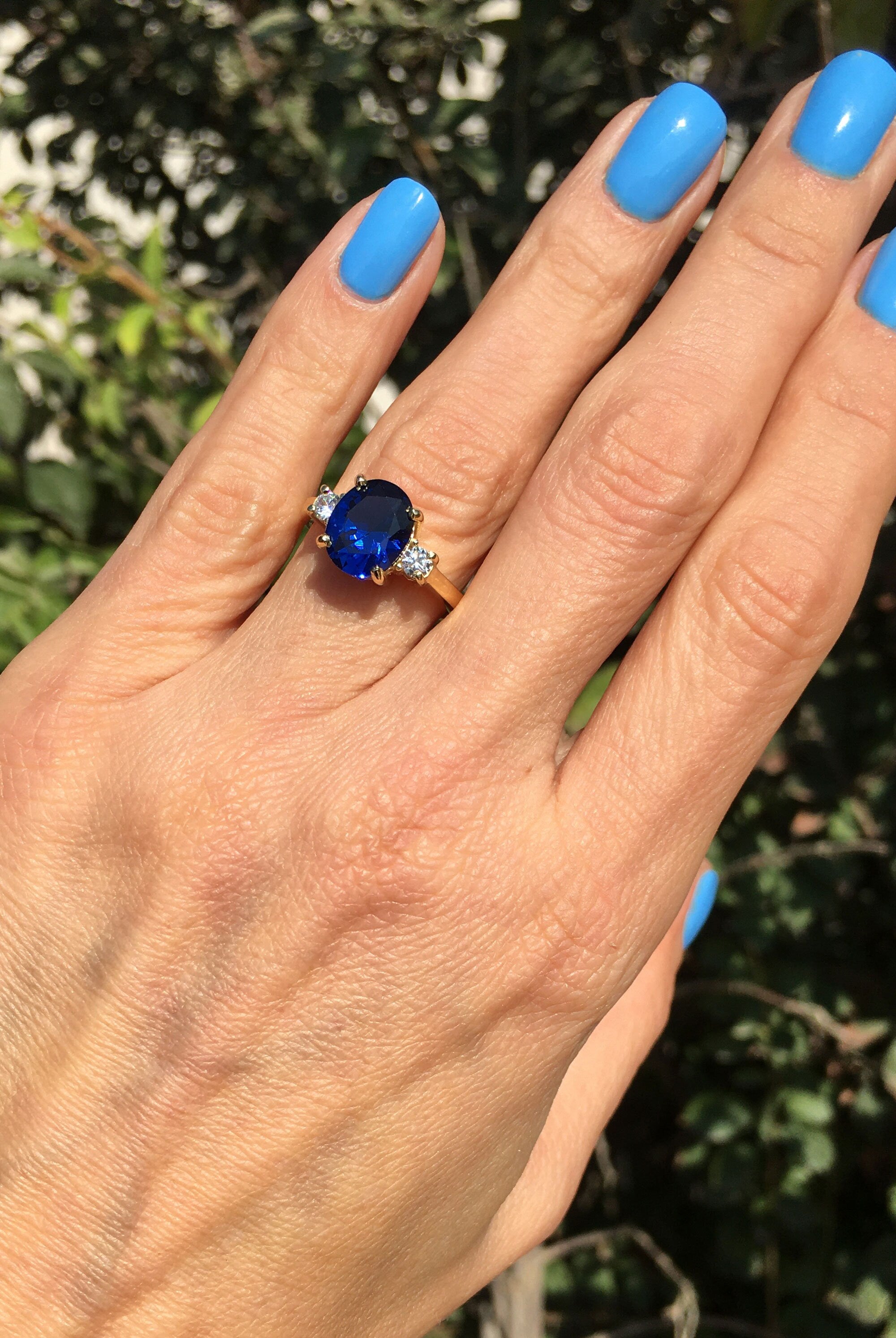 Blue Sapphire Ring - September Birthstone - Statement Engagement Ring with Oval Blue Sapphire Gemstone and Clear Quartz Accents - H.L.Jewelry