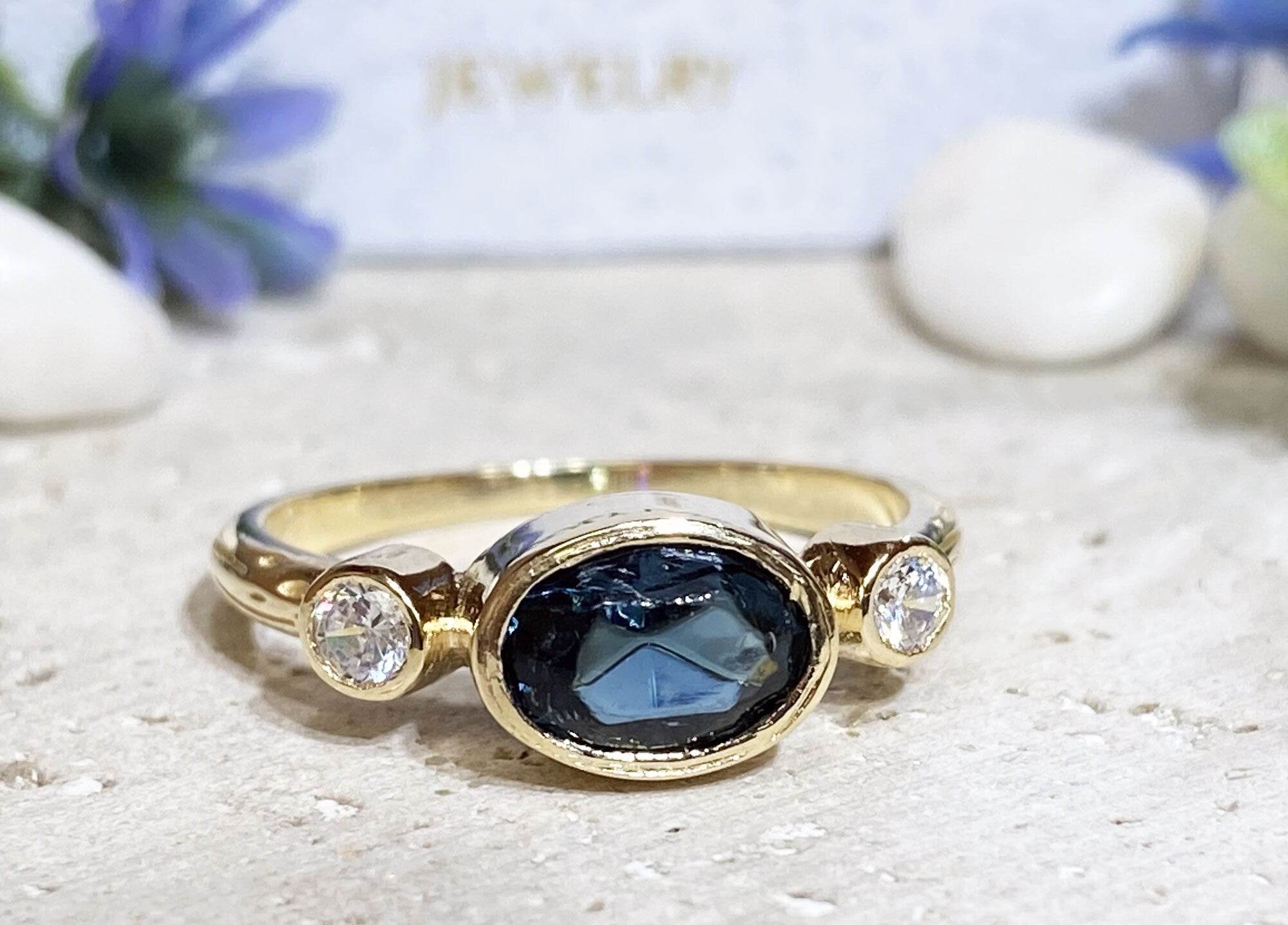 Blue Sapphire Ring - September Birthstone - Bezel Set Ring with Oval Blue Sapphire Gemstone and Clear Quartz Accents - H.L.Jewelry