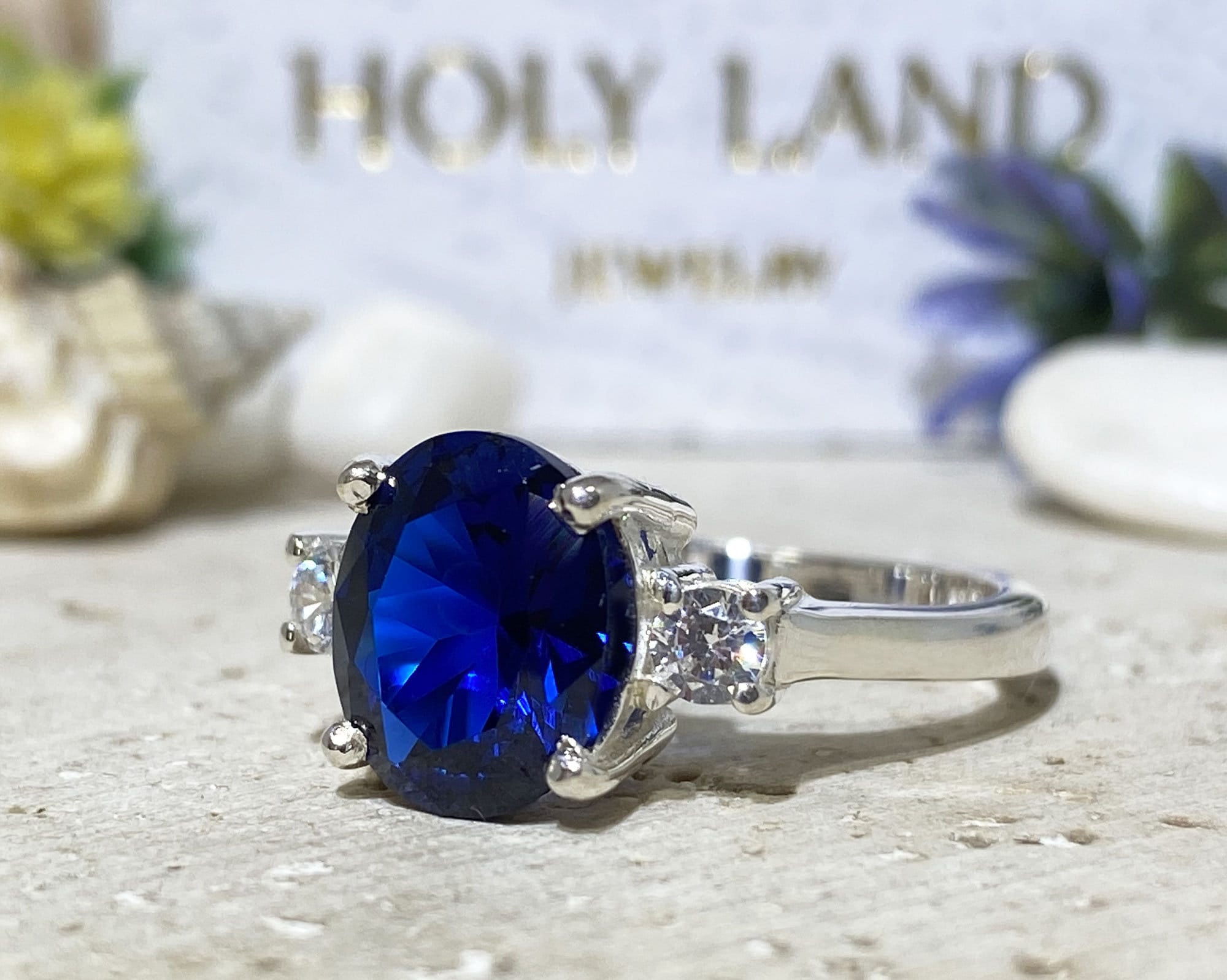 Blue Sapphire Ring - September Birthstone - Statement Engagement Ring with Oval Blue Sapphire Gemstone and Clear Quartz Accents - H.L.Jewelry