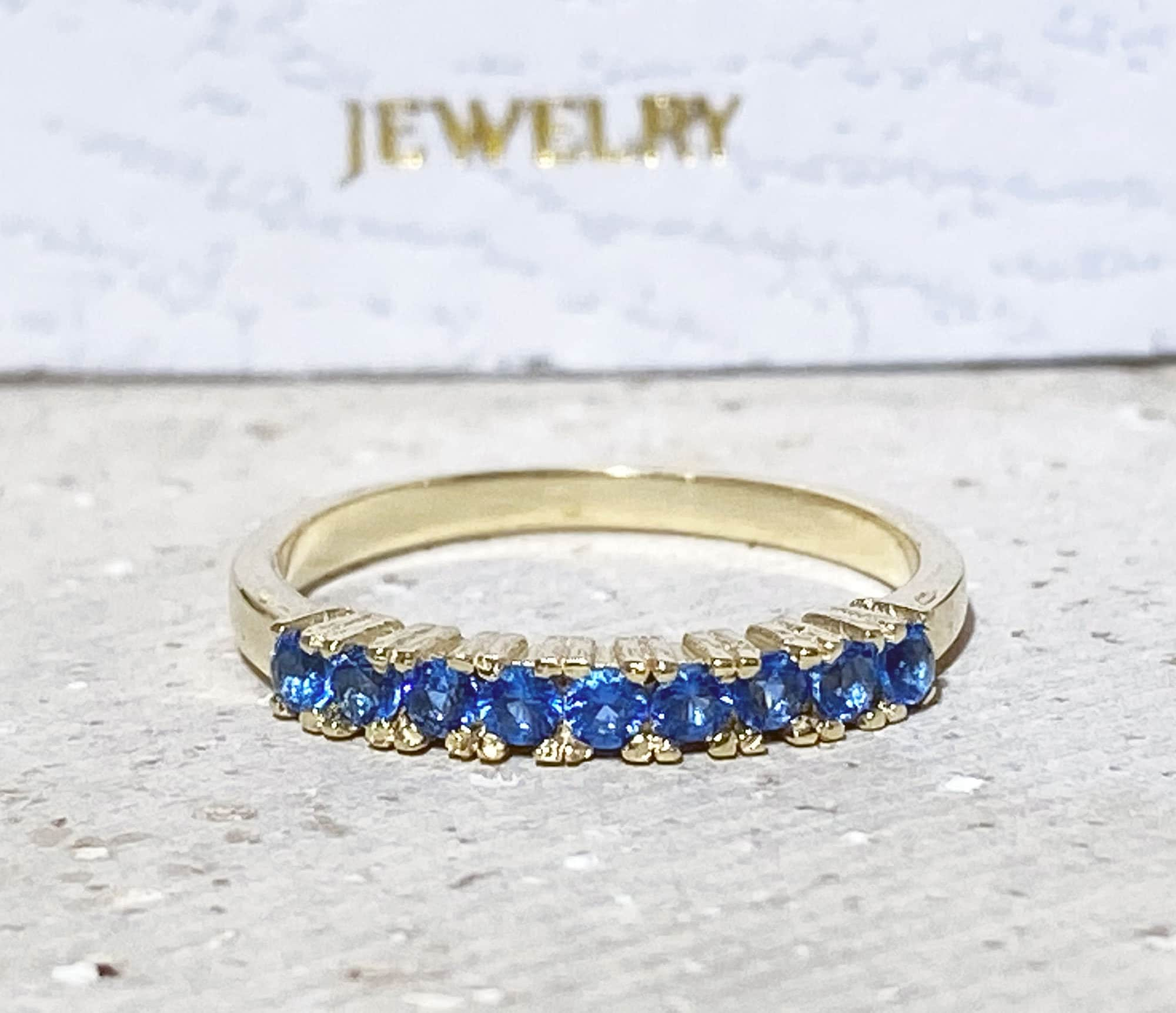 Blue Topaz Ring - December Birthstone - Delicate Stacking Half Eternity Ring with Nine Round Blue Topaz Gemstones - H.L.Jewelry