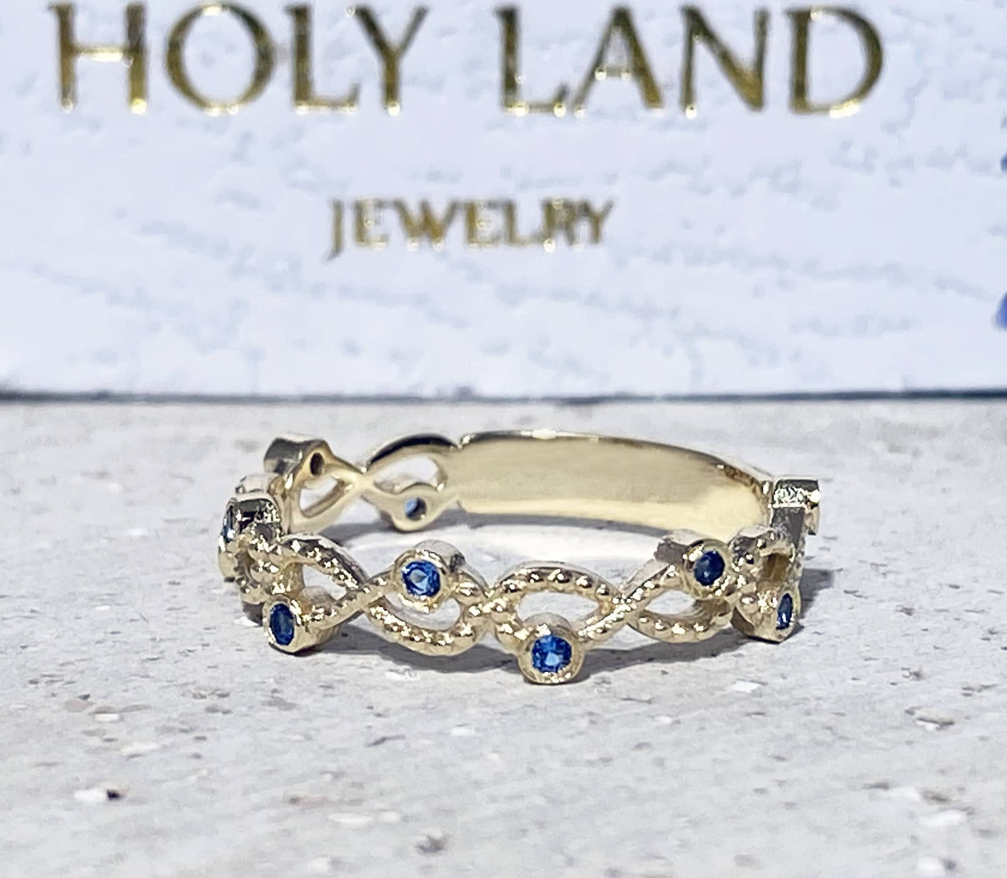 Blue Topaz Ring - December Birthstone - Infinity Ring with Small Round Blue Topaz Gemstones - H.L.Jewelry