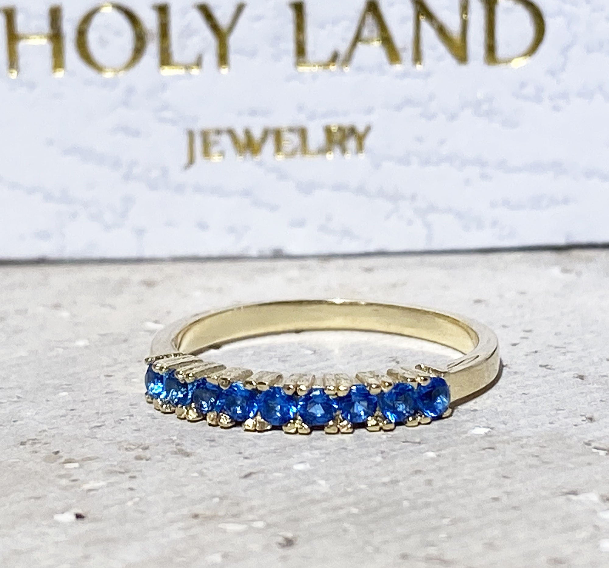 Blue Topaz Ring - December Birthstone - Delicate Stacking Half Eternity Ring with Nine Round Blue Topaz Gemstones - H.L.Jewelry