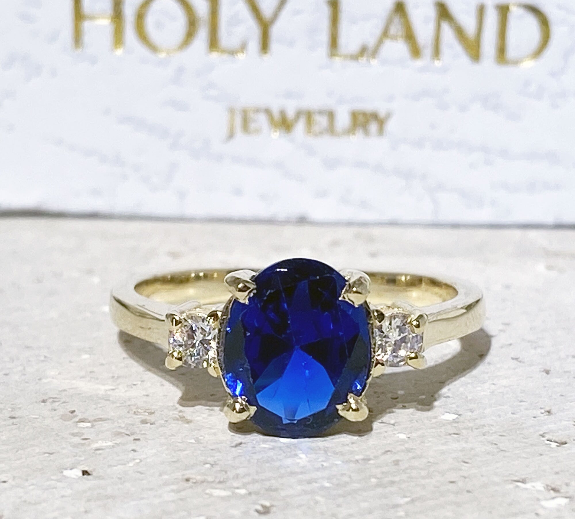 Blue Sapphire Ring - September Birthstone - Statement Engagement Ring with Oval Blue Sapphire Gemstone and Clear Quartz Accents - H.L.Jewelry