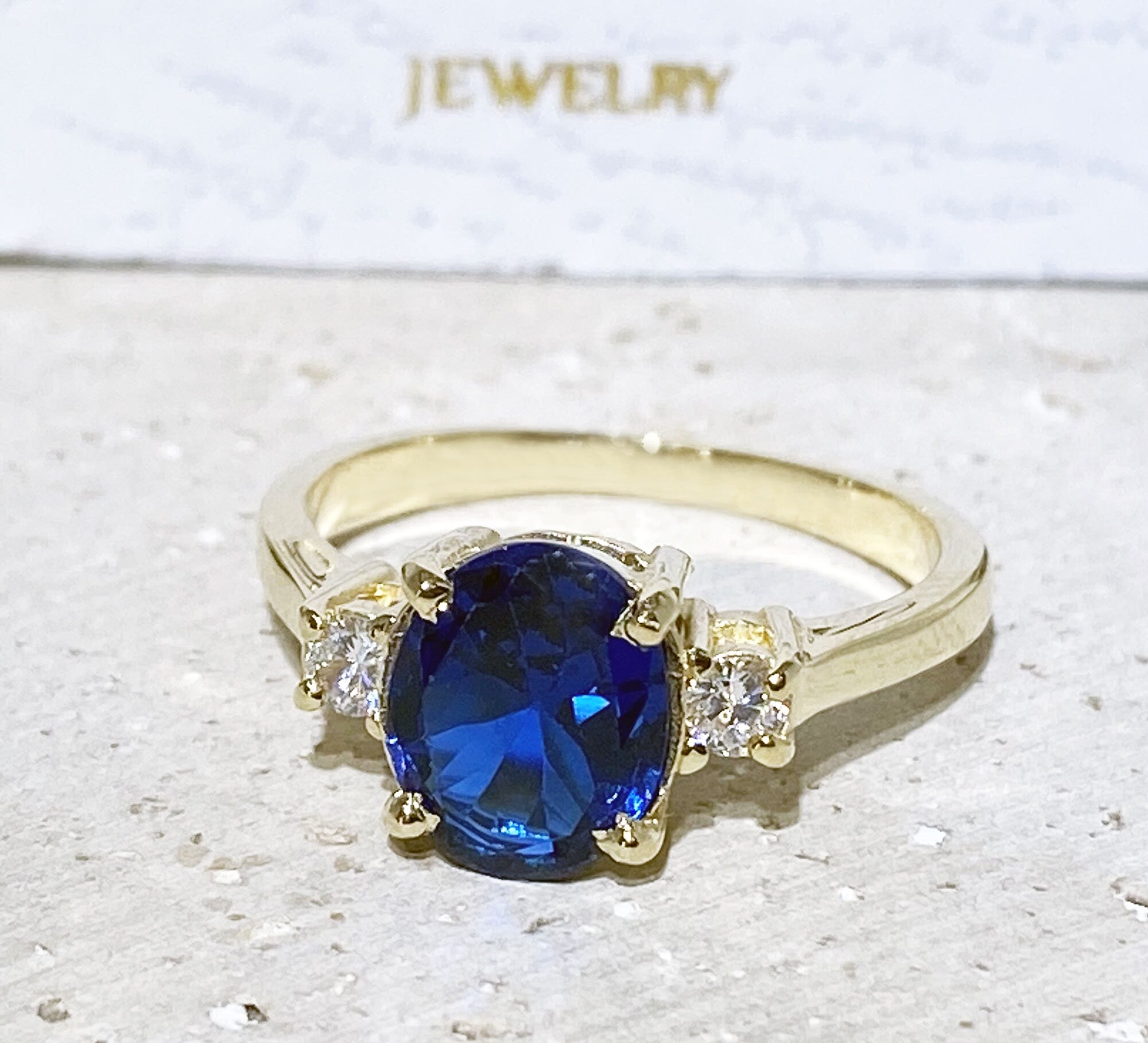 Blue Sapphire Ring - September Birthstone - Statement Engagement Ring with Oval Blue Sapphire Gemstone and Clear Quartz Accents - H.L.Jewelry