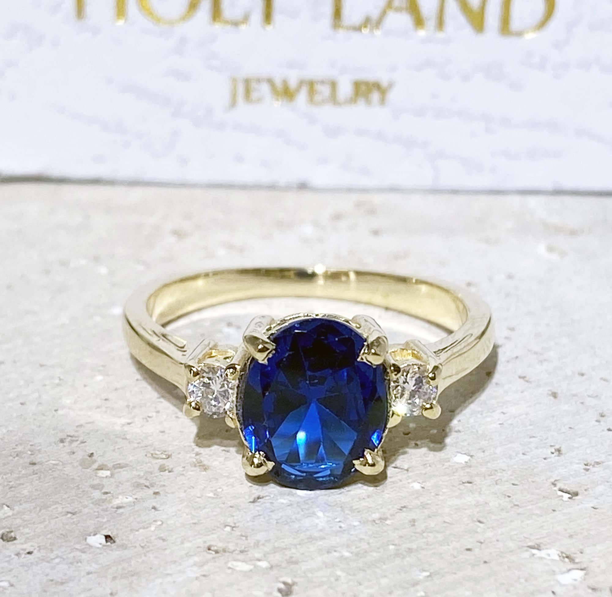 Blue Sapphire Ring - September Birthstone - Statement Engagement Ring with Oval Blue Sapphire Gemstone and Clear Quartz Accents - H.L.Jewelry