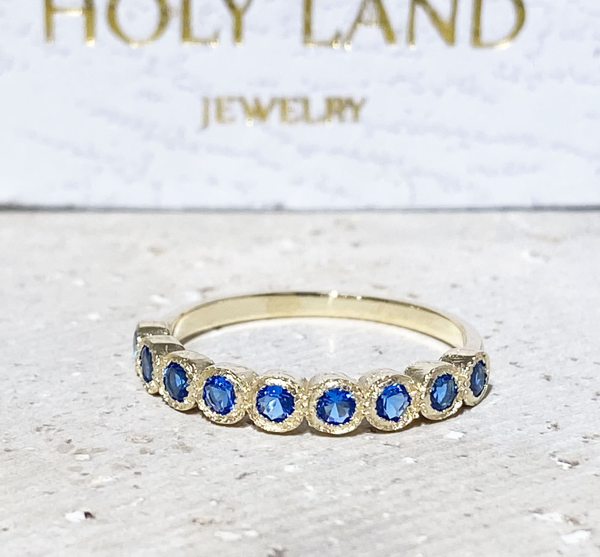 Blue Topaz Ring - December Birthstone - Delicate Stacking Half Eternity Ring with Nine Round Blue Topaz Gemstones - H.L.Jewelry