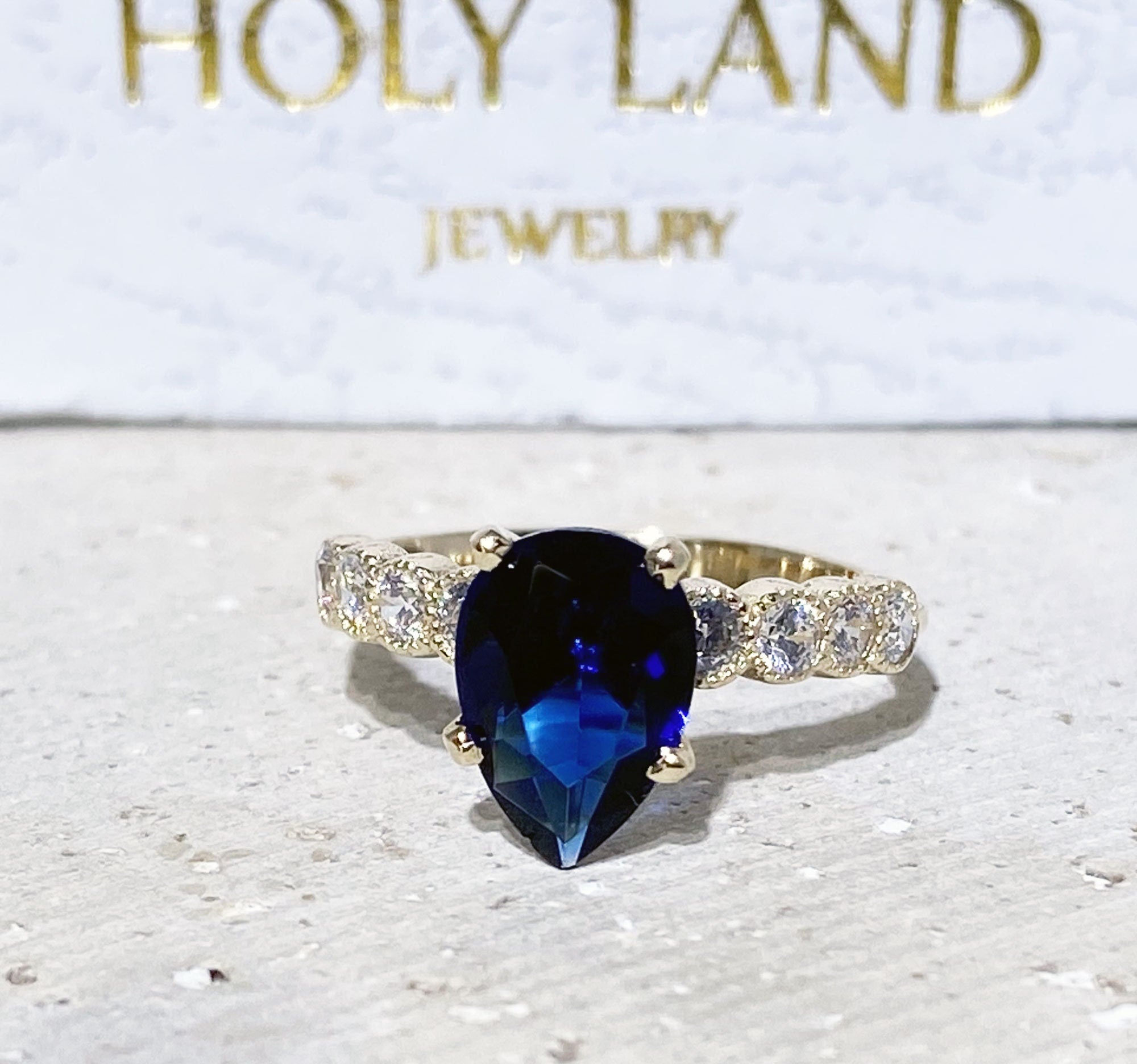 Blue Sapphire Ring - September Birthstone - Statement Engagement Ring with Pear-Shaped Blue Sapphire Gemstone and Clear Quartz Accents - H.L.Jewelry