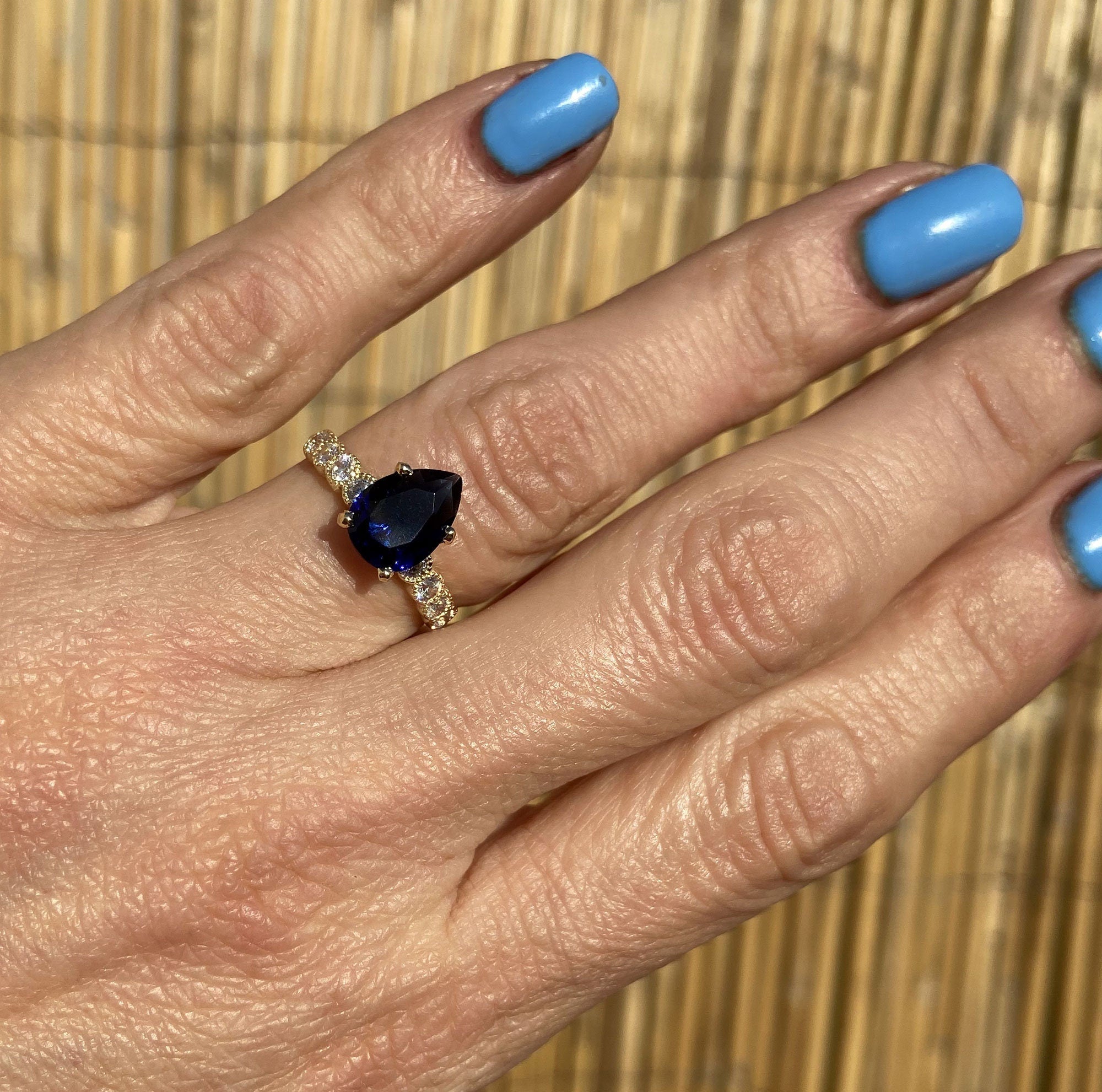 Blue Sapphire Ring - September Birthstone - Statement Engagement Ring with Pear-Shaped Blue Sapphire Gemstone and Clear Quartz Accents - H.L.Jewelry