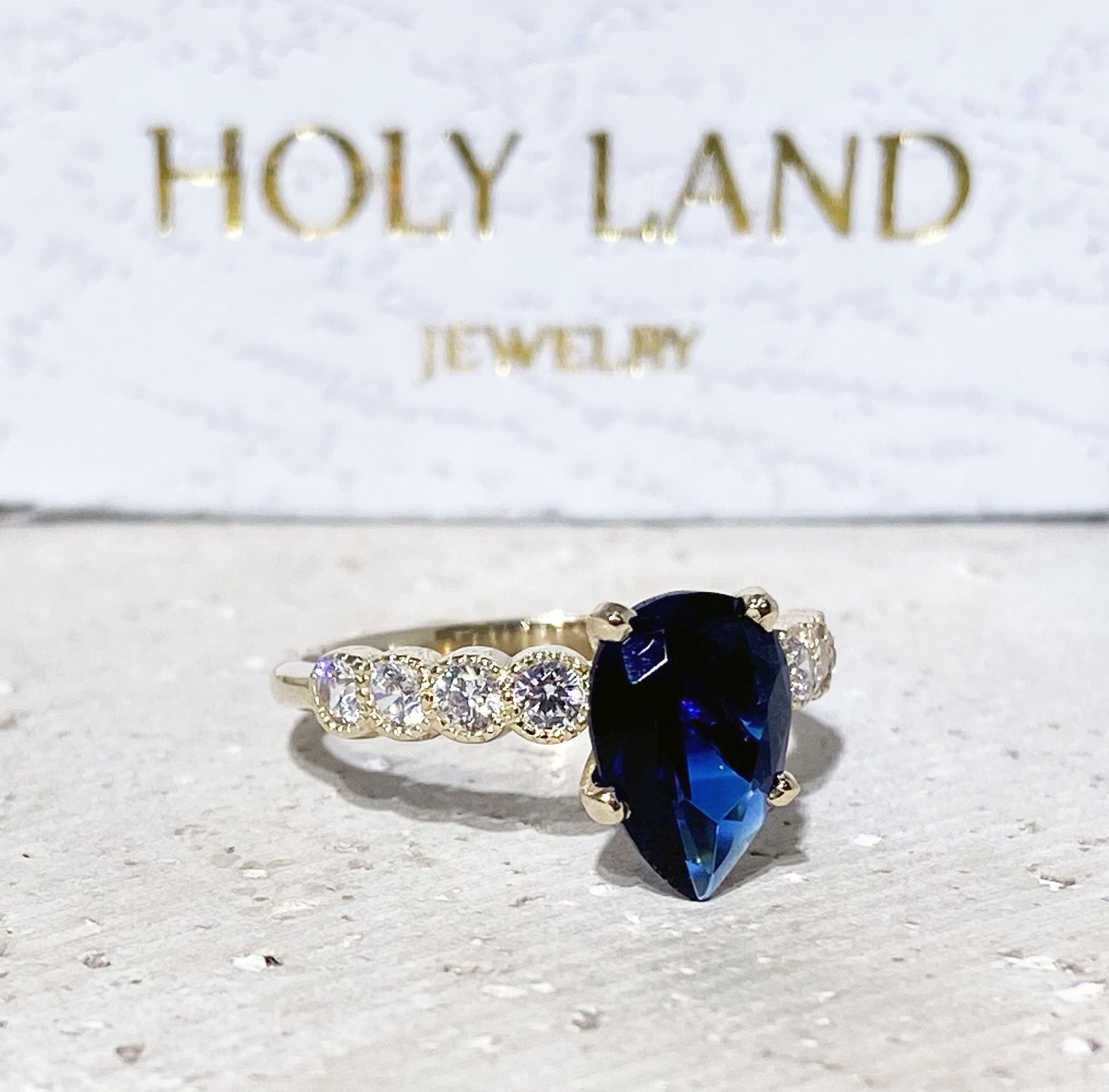 Blue Sapphire Ring - September Birthstone - Statement Engagement Ring with Pear-Shaped Blue Sapphire Gemstone and Clear Quartz Accents - H.L.Jewelry