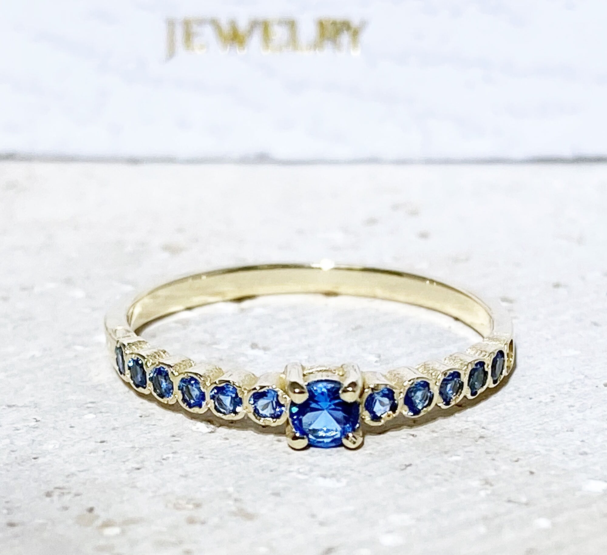 Blue Topaz Ring - December Birthstone - Delicate Stacking Half Eternity Ring with Thirteen Round Blue Topaz Gemstones - H.L.Jewelry