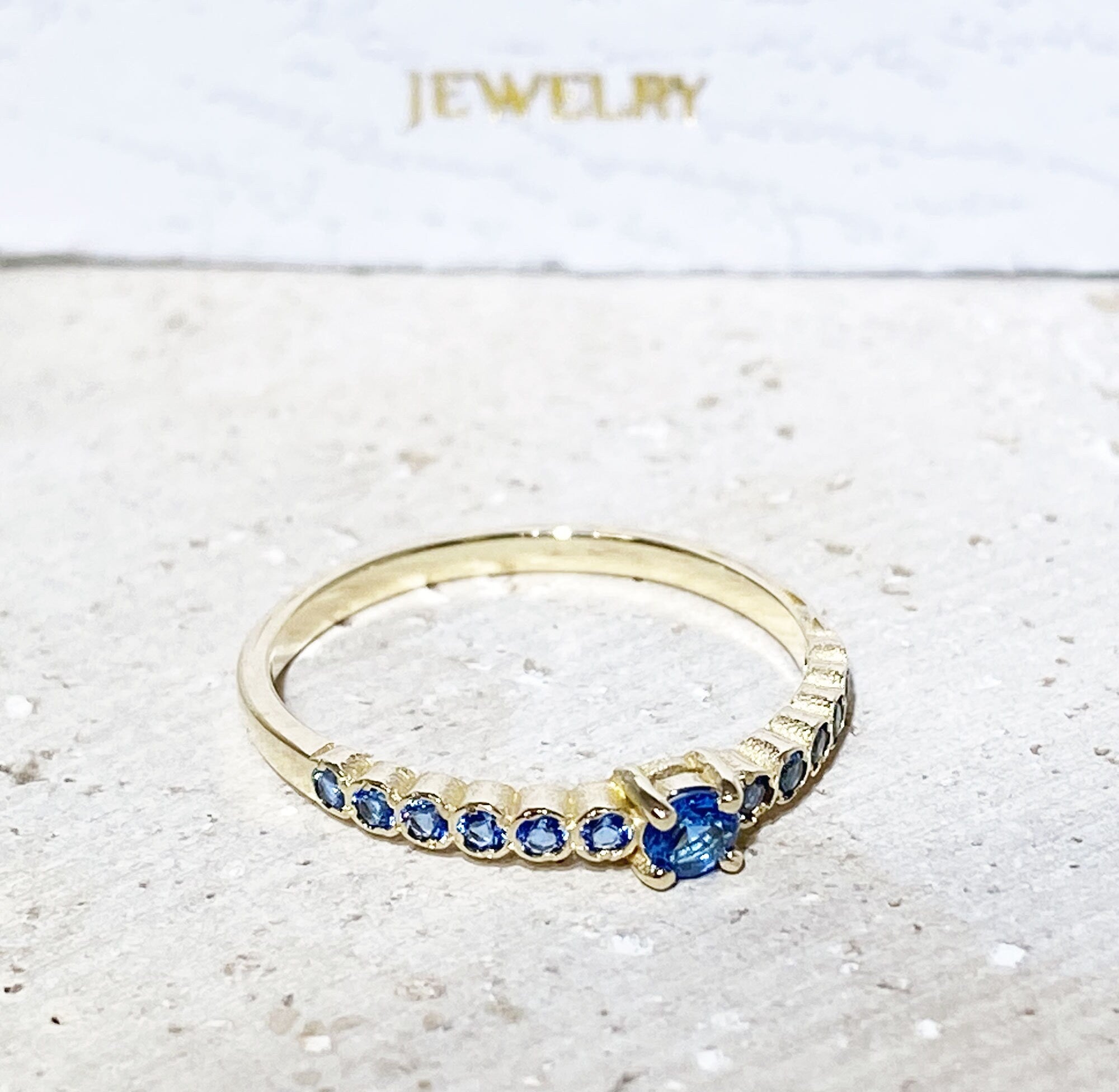 Blue Topaz Ring - December Birthstone - Delicate Stacking Half Eternity Ring with Thirteen Round Blue Topaz Gemstones - H.L.Jewelry