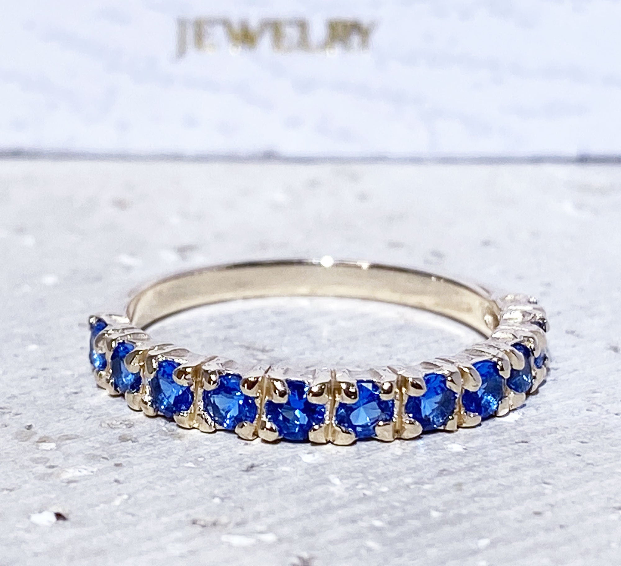 Blue Topaz Ring - December Birthstone - Delicate Stacking Half Eternity Ring with Eleven Round Blue Topaz Gemstones - H.L.Jewelry