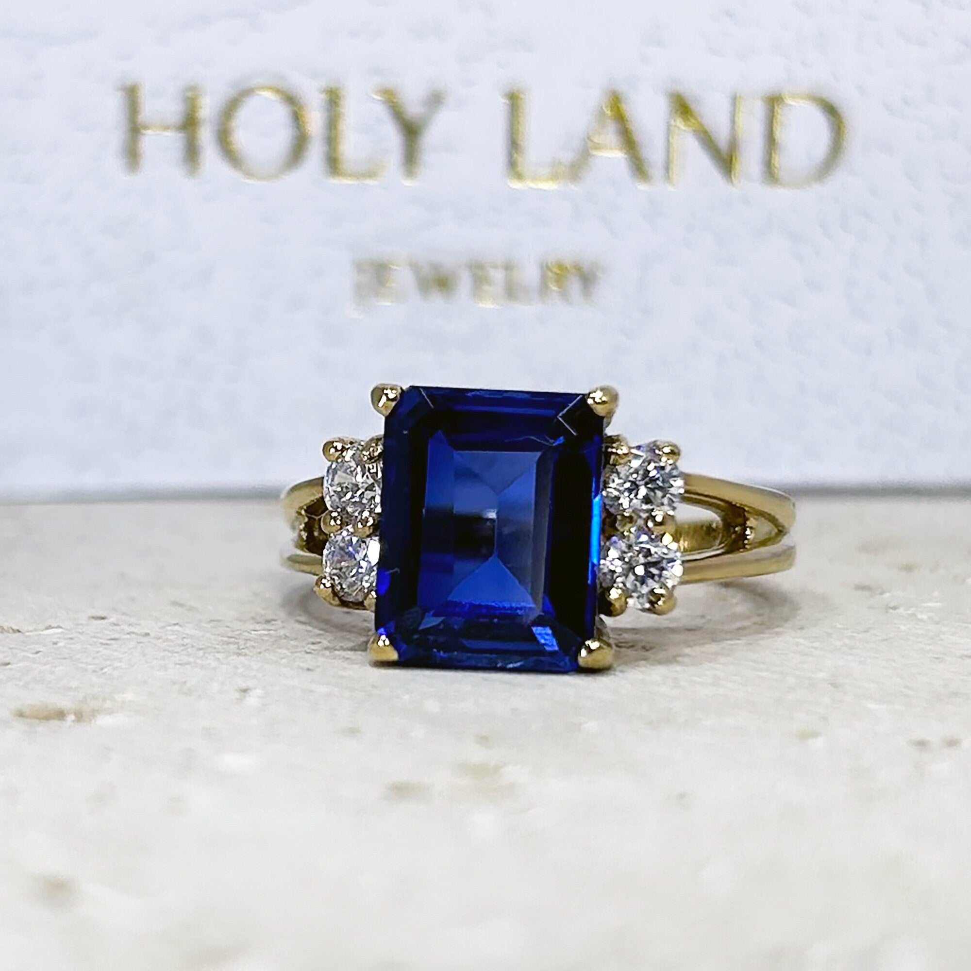 Blue Sapphire Ring - September Birthstone - Statement Engagement Ring with Emerald-Cut Blue Sapphire Gemstone and Clear Quartz Accents - H.L.Jewelry