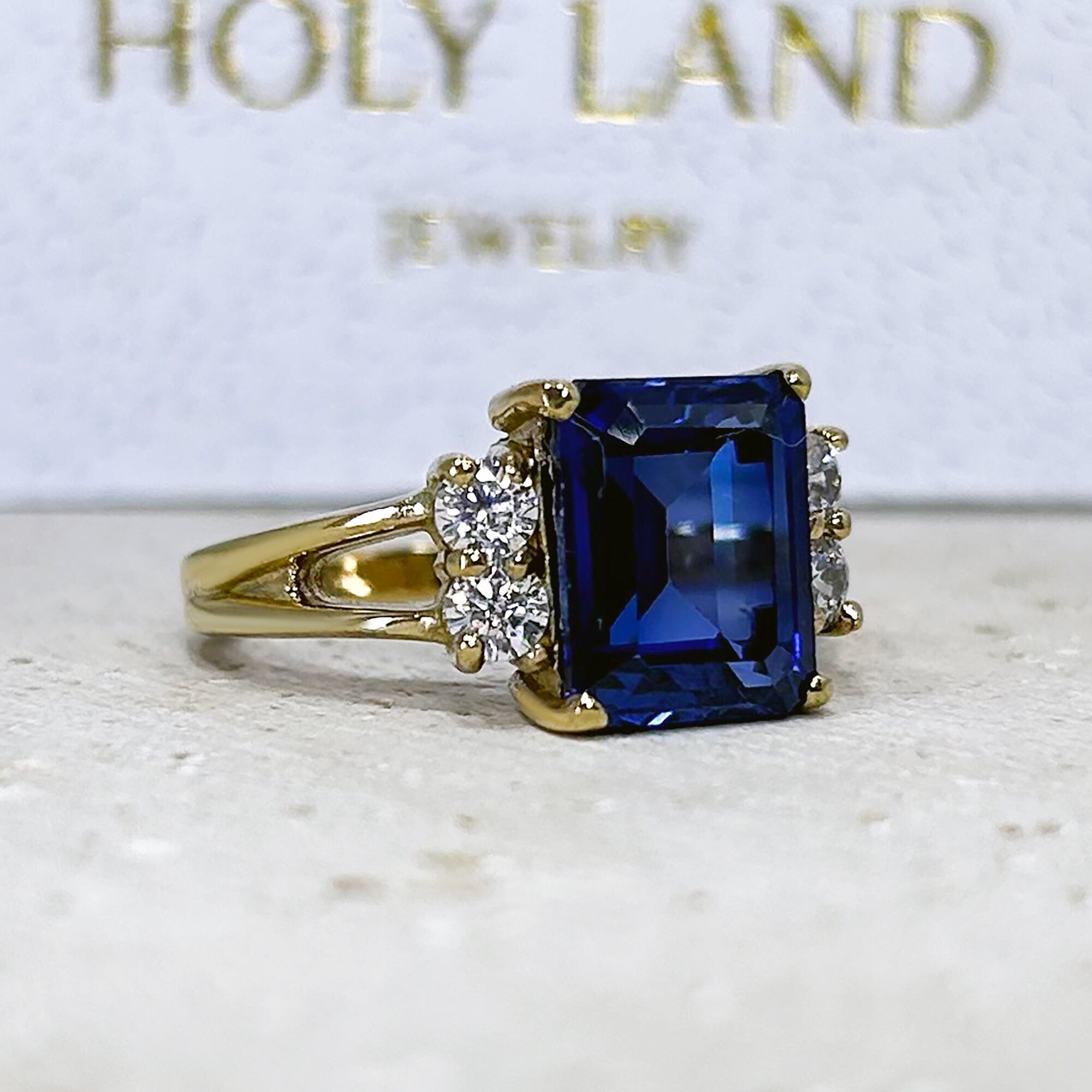 Blue Sapphire Ring - September Birthstone - Statement Engagement Ring with Emerald-Cut Blue Sapphire Gemstone and Clear Quartz Accents - H.L.Jewelry