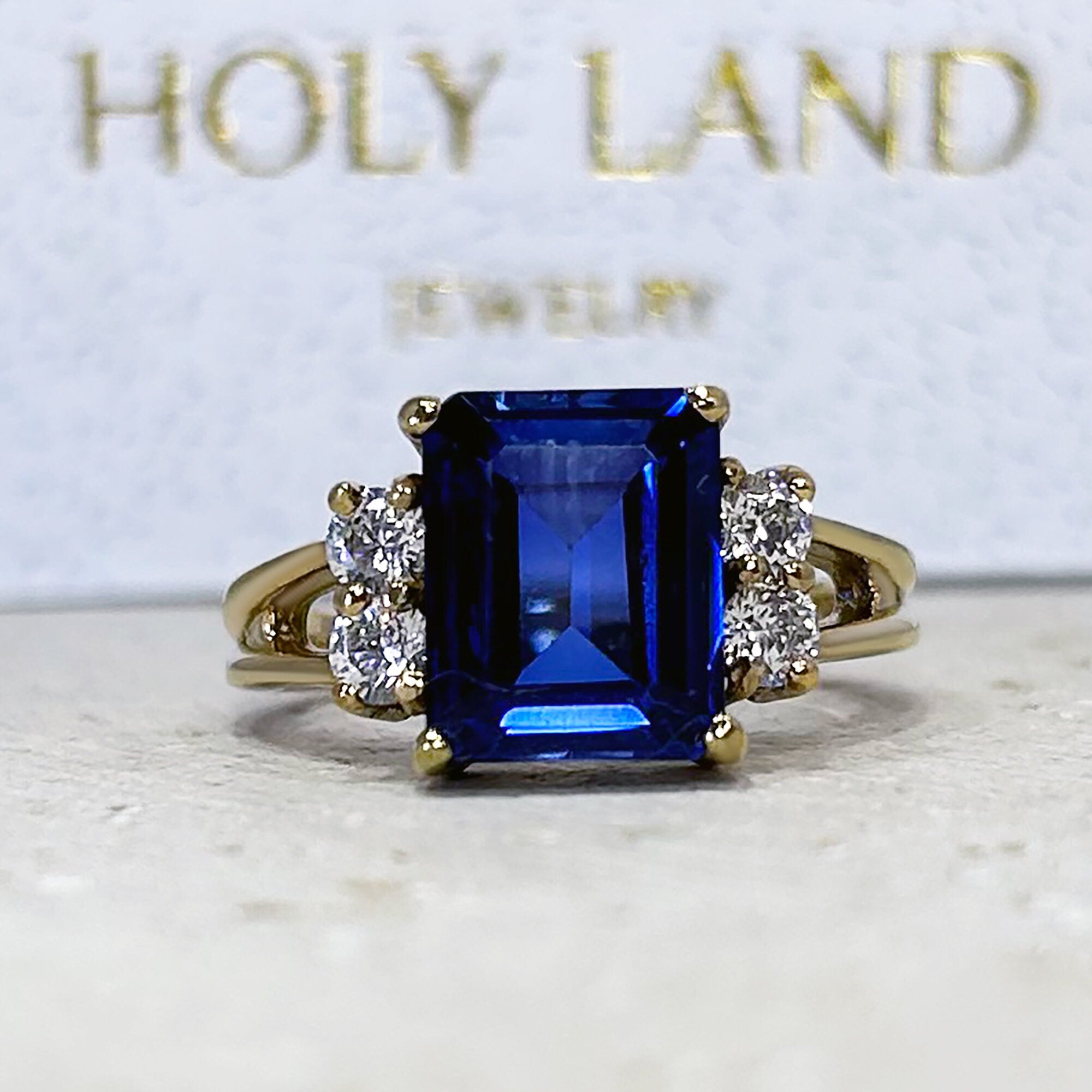 Blue Sapphire Ring - September Birthstone - Statement Engagement Ring with Emerald-Cut Blue Sapphire Gemstone and Clear Quartz Accents - H.L.Jewelry